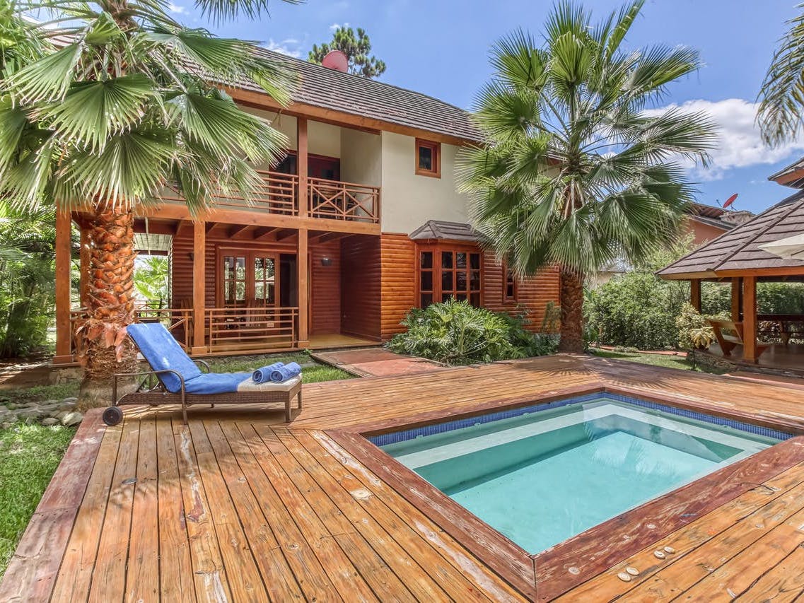backyard pool of Jarabacoa, La Vega vacation rental surrounded by palm trees
